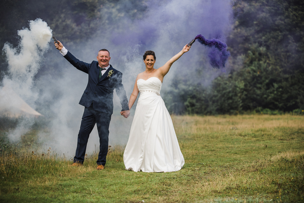 Bride and groom with smoke bombs
