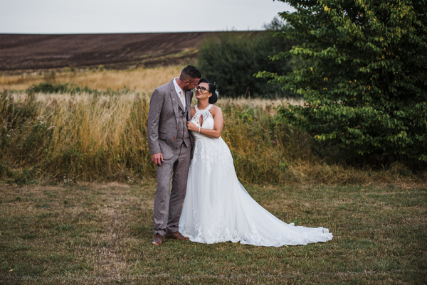 Bride and groom in fields